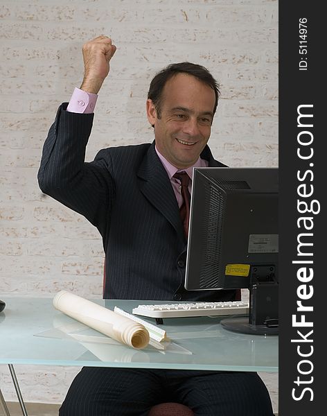 A shot of a businessman with his fist in the air in excitement. A shot of a businessman with his fist in the air in excitement.