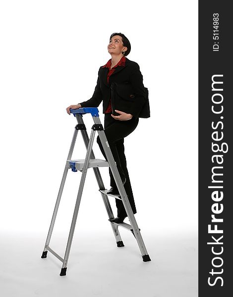 Woman in a business suit climbing a stepladder with her gaze firmly focused on the ceiling. Isolated against a white background. Woman in a business suit climbing a stepladder with her gaze firmly focused on the ceiling. Isolated against a white background.