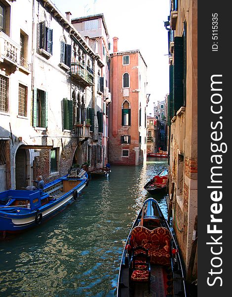 One of many canals in Venice and boats in it