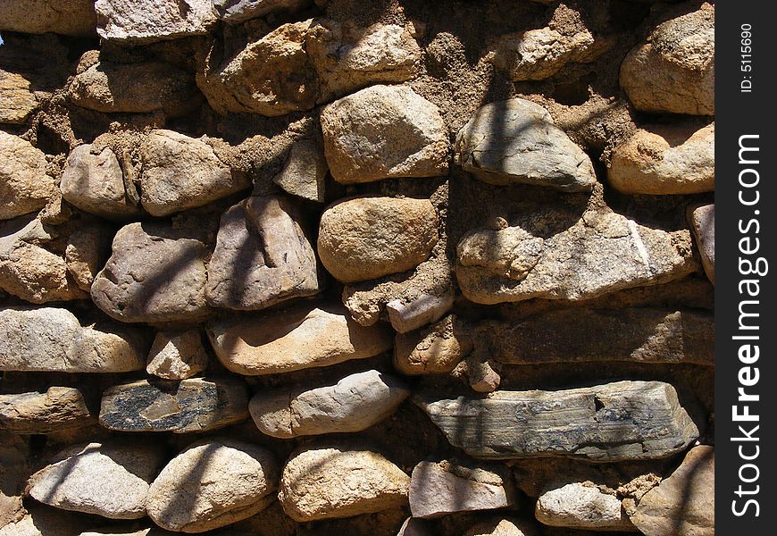 Old stone and mortar wall, part of an old homestead, used as a storage building. Old stone and mortar wall, part of an old homestead, used as a storage building.