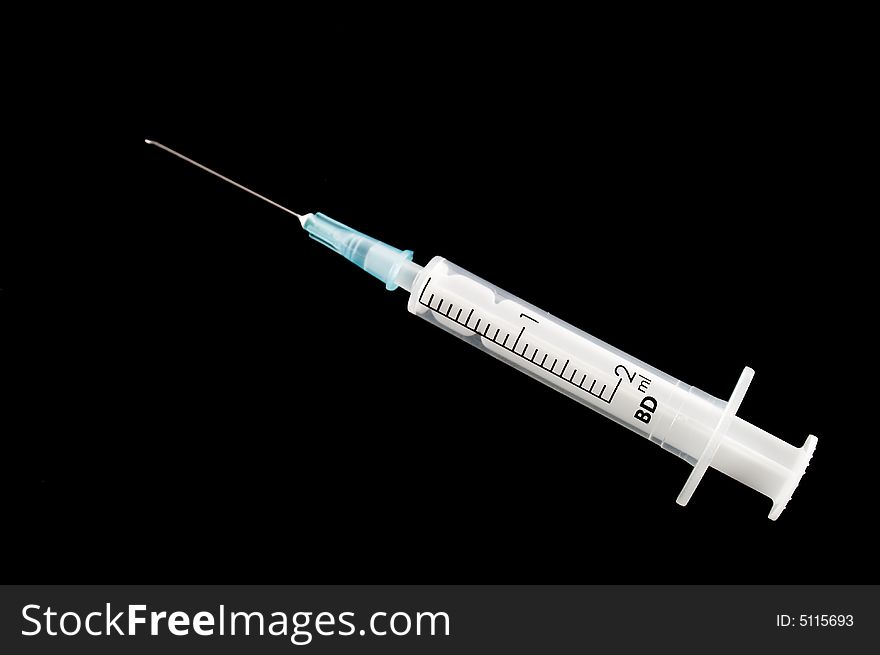 Syringe on a black background