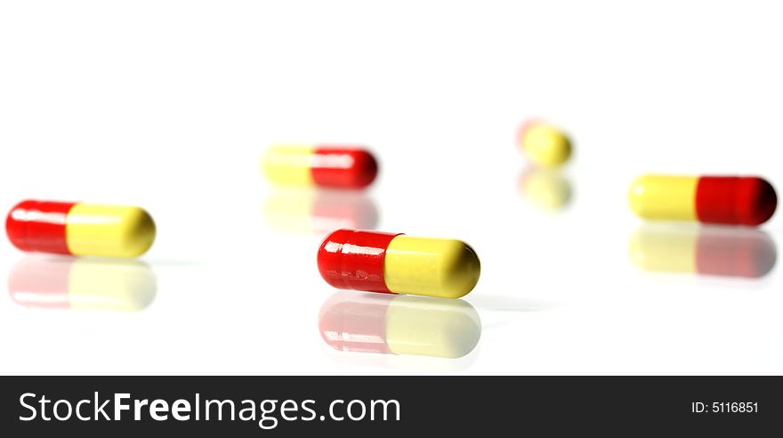 Pills on white, to be used for healthier living. Pills on white, to be used for healthier living