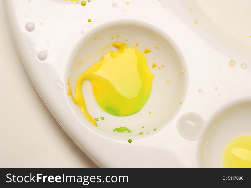 Paint palette with yellow and green watercolors.
