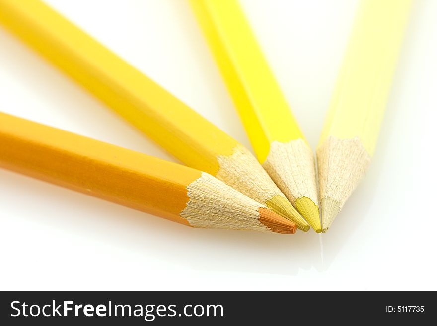 Variously tinted yellow pencils on a white background. Variously tinted yellow pencils on a white background