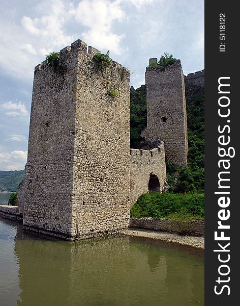 Old stone Serbian fortification on Danube in national park Djerdap, tower in water. Old stone Serbian fortification on Danube in national park Djerdap, tower in water