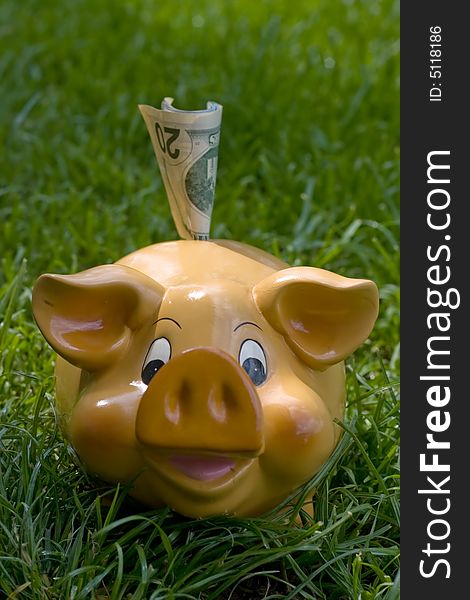 Piggy bank with money in upper slot