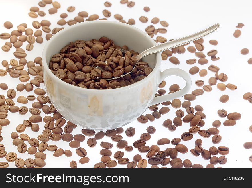 Coffee cup with coffee beans on white background