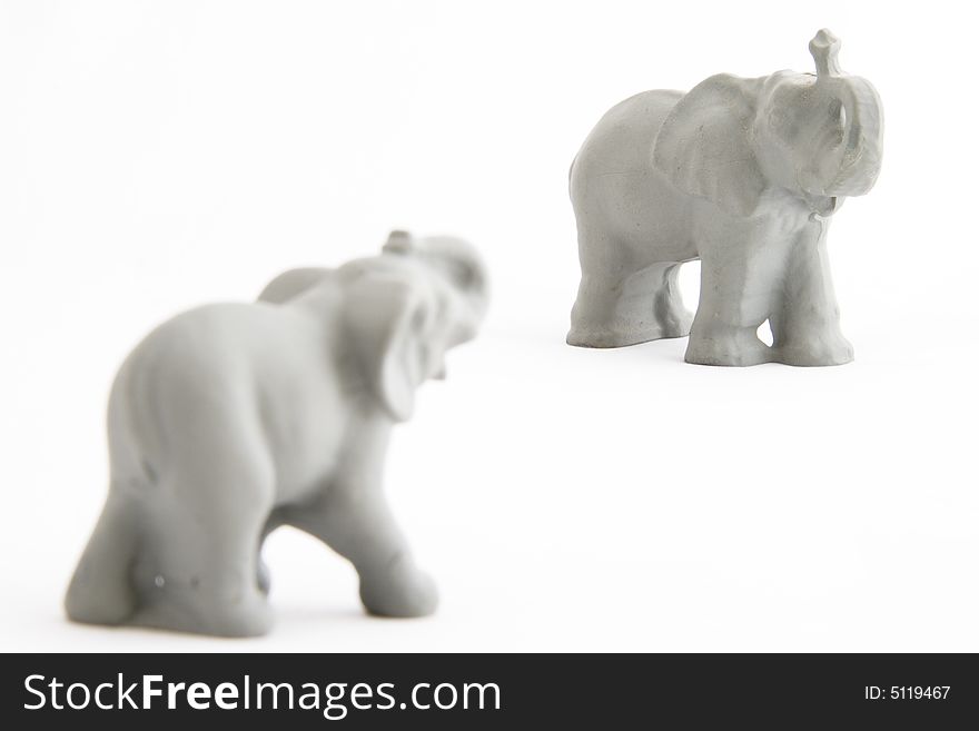 Two grey powerful elephants on a white background