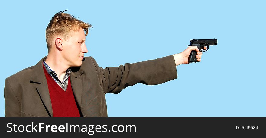 A young man standing with a gun