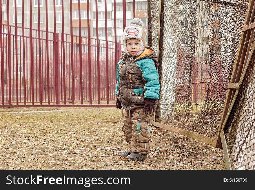 Child standing near the fence