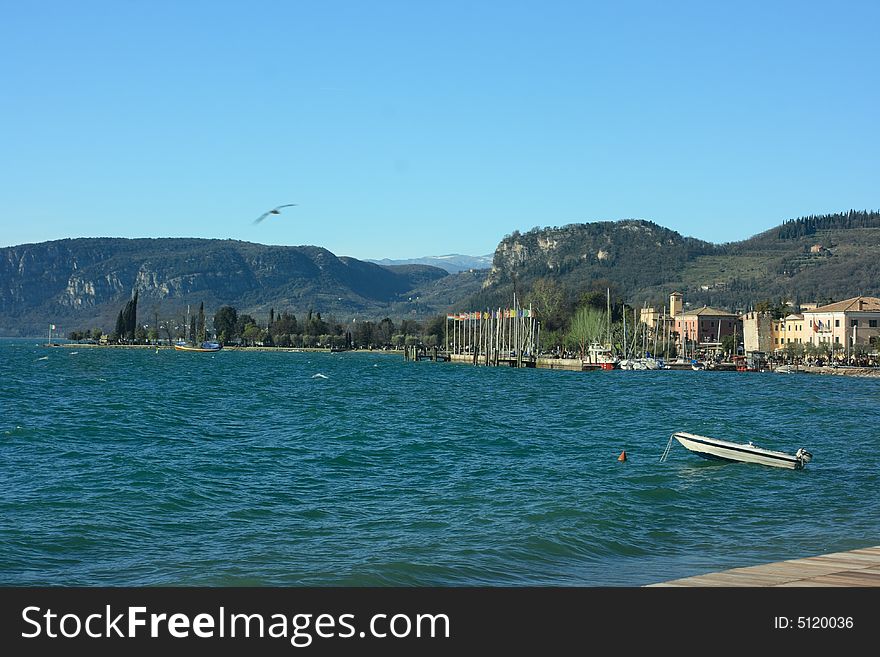 Lake Garda coast and mountains on horizon. Lake Garda coast and mountains on horizon