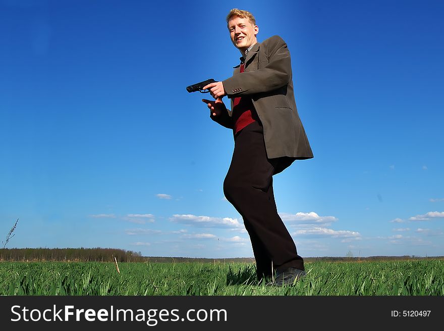 Young man walking with a gun. Young man walking with a gun.