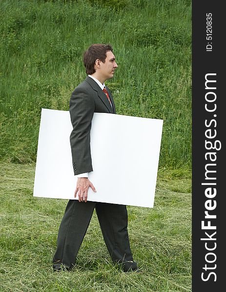 Businessman with sheet of paper outdoor
