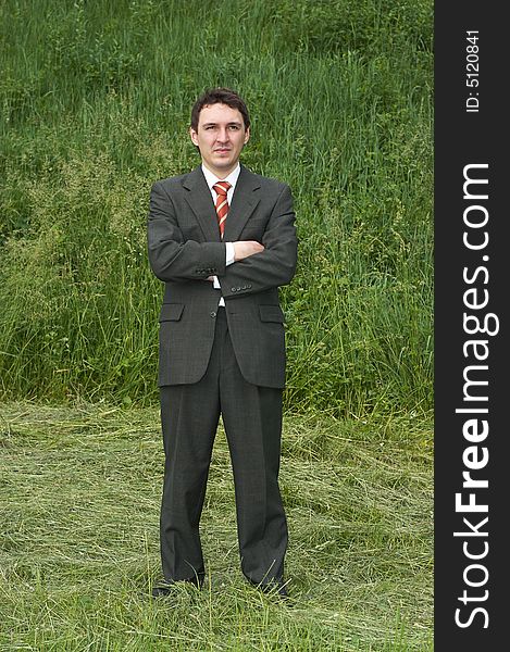 Businessman standing alone on field outdoor. Businessman standing alone on field outdoor