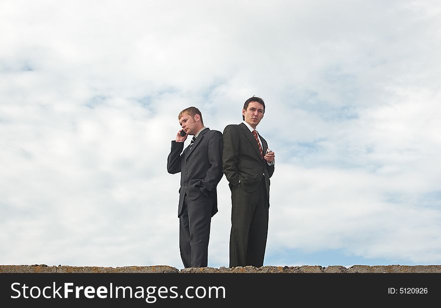 Businessmen talking under the skies. Businessmen talking under the skies