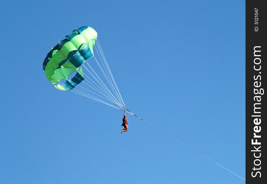 The woman flies on a parachute