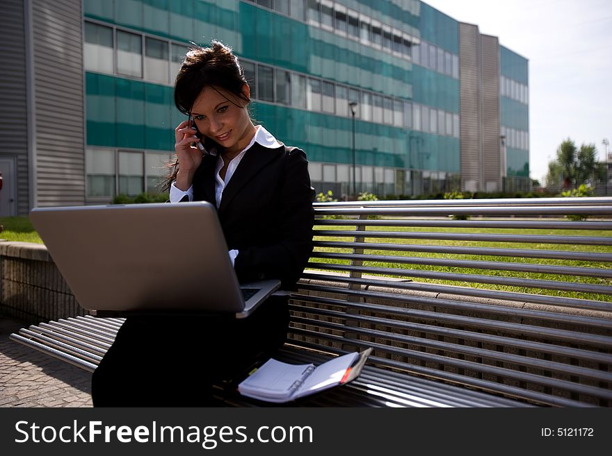 Working outdoors with mobile and laptop. Working outdoors with mobile and laptop