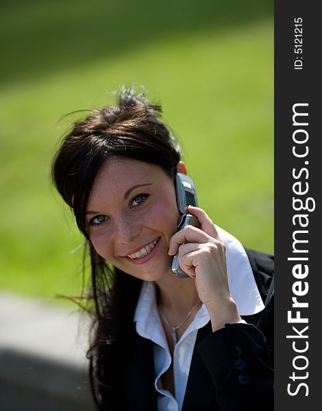 Portrait of a young businesswoman making a phone call with a mobile. Portrait of a young businesswoman making a phone call with a mobile