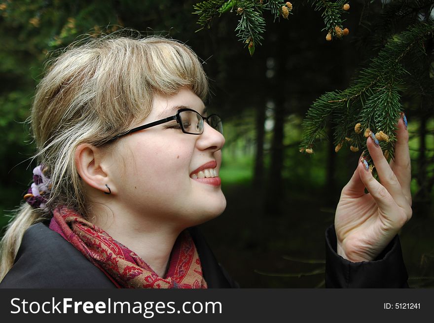 Caucasian girl by branches of evergreen fir-tree. Close-ups portrait. Caucasian girl by branches of evergreen fir-tree. Close-ups portrait.
