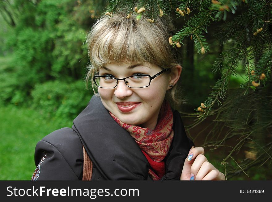 Caucasian girl by branches of evergreen fir-tree. Portrait. Caucasian girl by branches of evergreen fir-tree. Portrait.