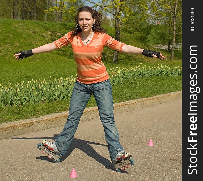 Smiling Rollerskating Girl Outdoors on Green Background