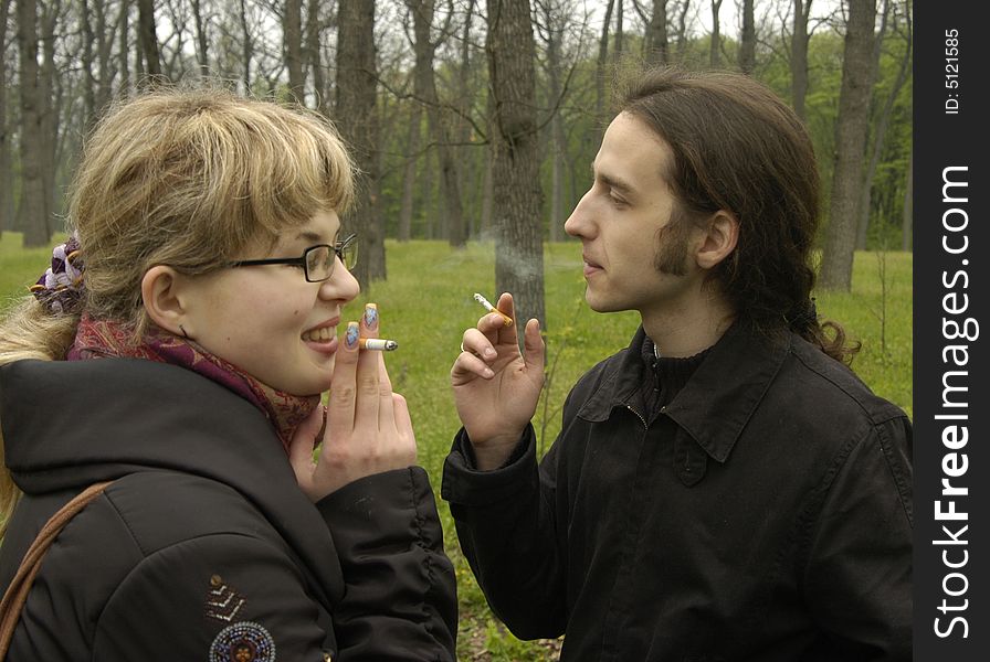 Girl and man are smoking