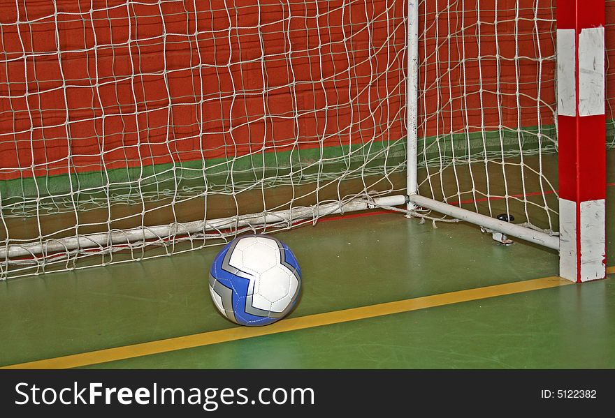 Ball in the goal-net in the gym - sport symbols