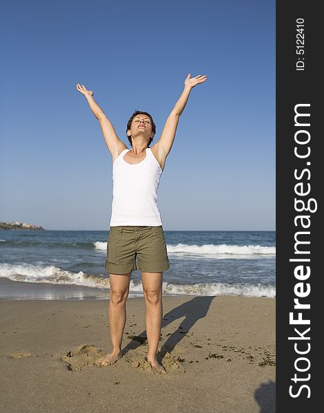 Young girl exercises gymnastics on the beach