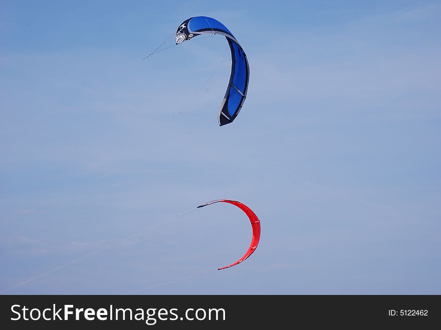 Red and blue kites flying in the sky. Red and blue kites flying in the sky