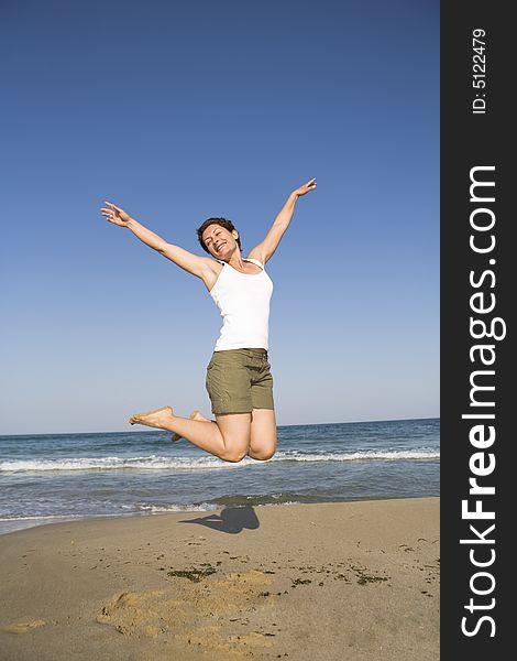 Young girl jumping on the beach