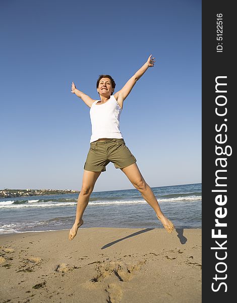 Young girl jumping on the beach