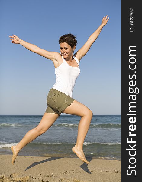 Young girl jumping on the beach