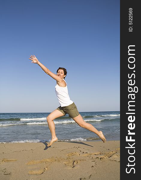 Young girl jumping on the beach