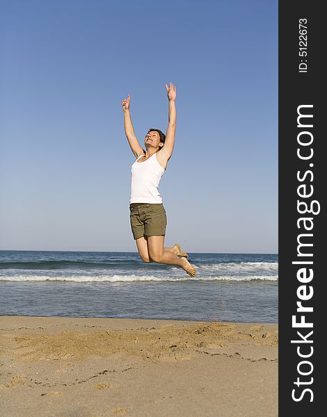 Young girl jumping on the beach