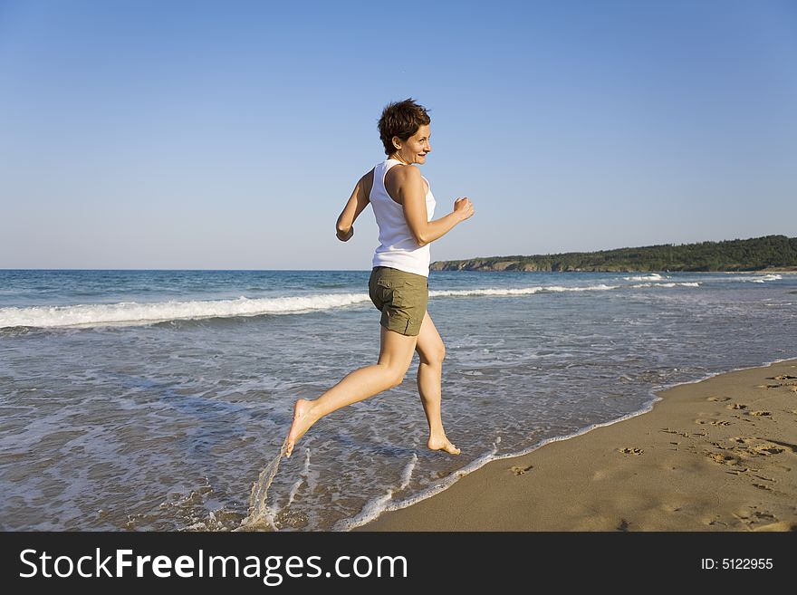 Young girl running on the beach