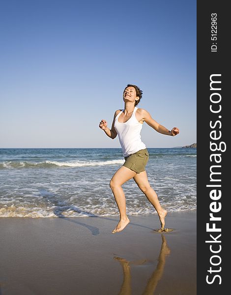 Young girl running on the beach