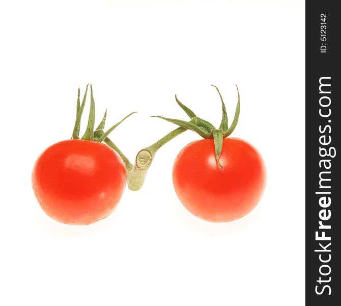 Two vine tomatoes isolated on a white background