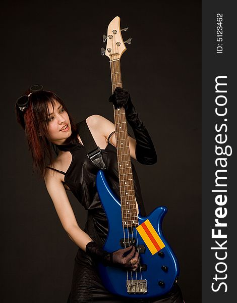 Beautiful girl playing bass guitar isolated in studio. Beautiful girl playing bass guitar isolated in studio