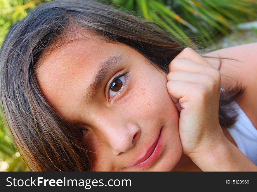 Headshot of a young child with his hand on his face. Headshot of a young child with his hand on his face.