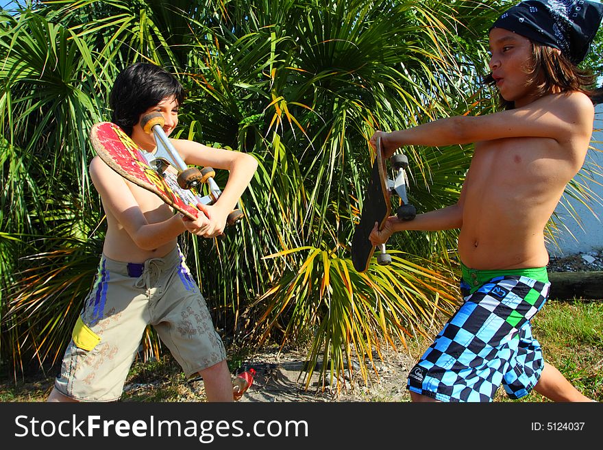 Two kids fighting with skateboards. Two kids fighting with skateboards.