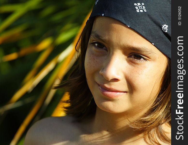 Head and shoulder shot of a young kid wearing a bandanna. Head and shoulder shot of a young kid wearing a bandanna.