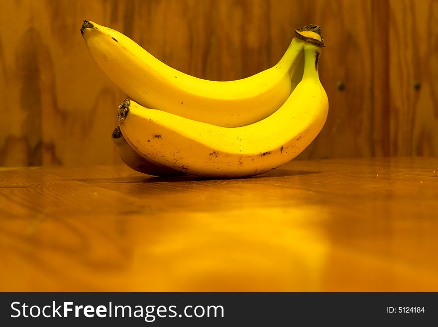 Bananas lyings on the wooden table, yellow fruit