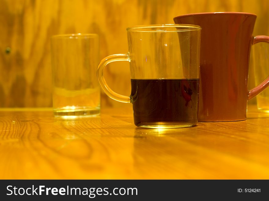 Two glasses and mug the photo on the wooden table. Two glasses and mug the photo on the wooden table