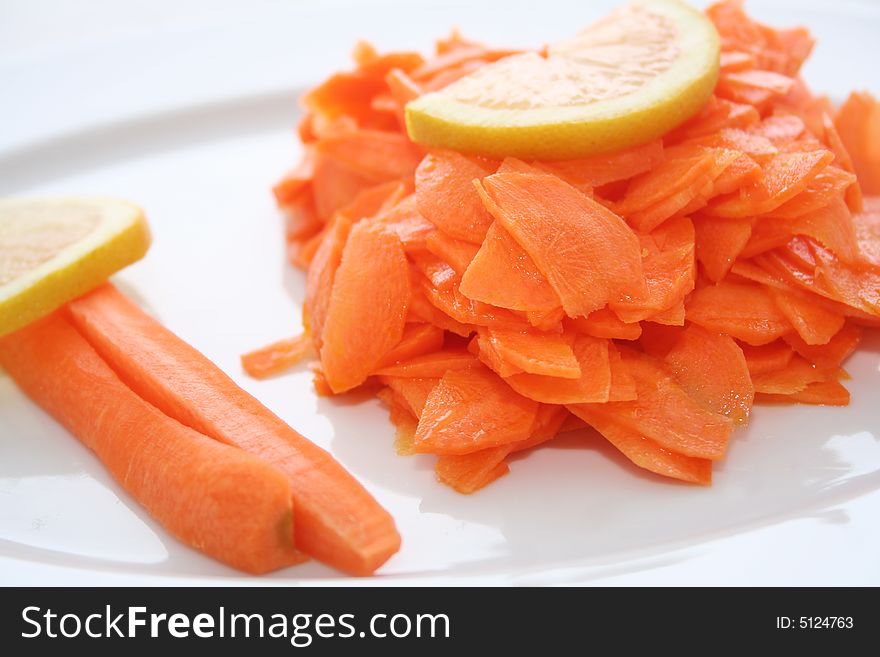 Fresh carrot salad with 2 peaces of lemon