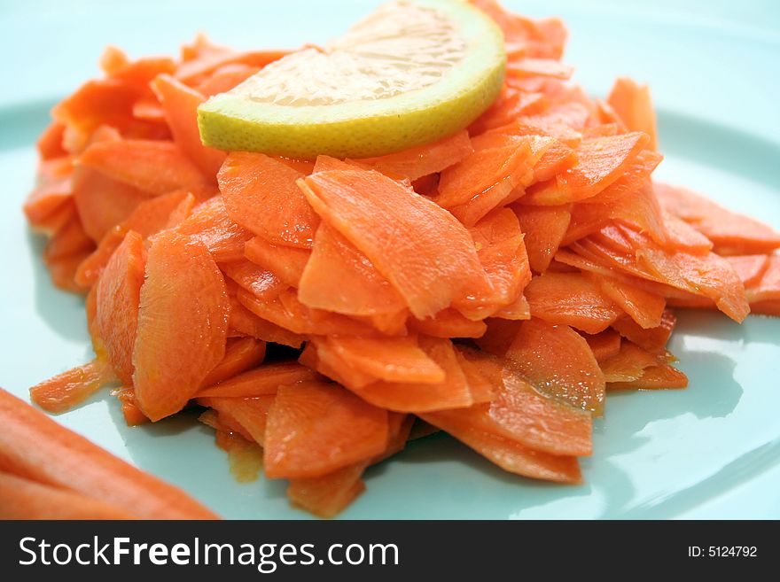 Fresh carrot salad with a peace of lemon