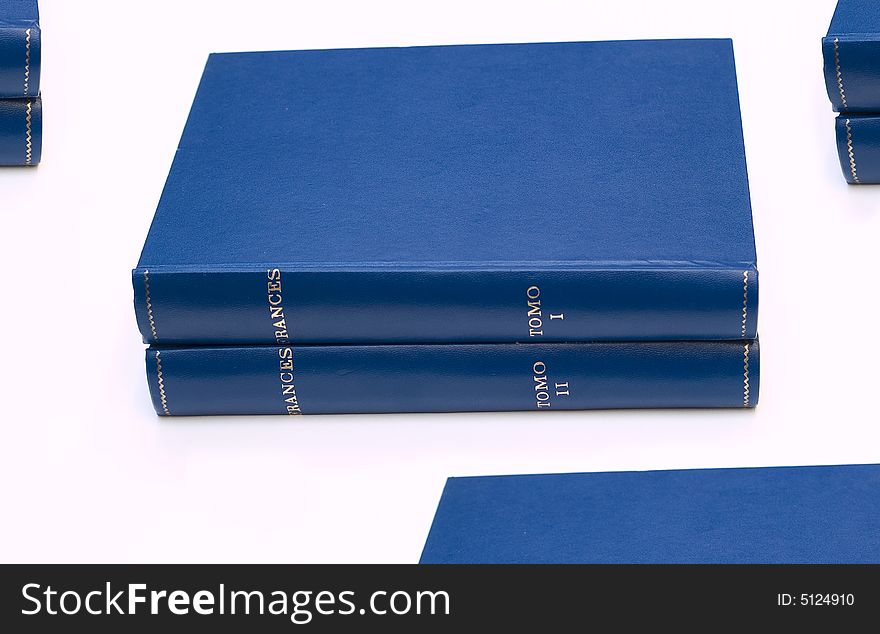 Stacks of books on white background.