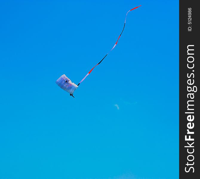 Skydiver with trailing pendant  in red, white and blue. Skydiver with trailing pendant  in red, white and blue