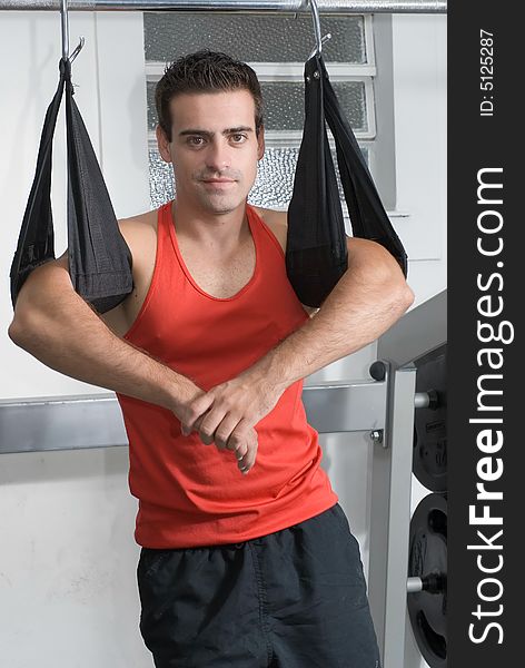 A shot of a handsome male standing in a gym. A shot of a handsome male standing in a gym.