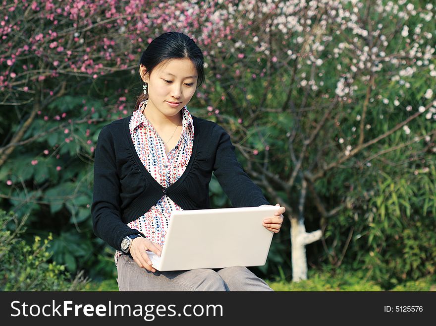 Woman studying on PC in park. Woman studying on PC in park