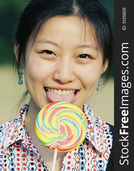 Young asian girl with colorful Lollipop. Young asian girl with colorful Lollipop